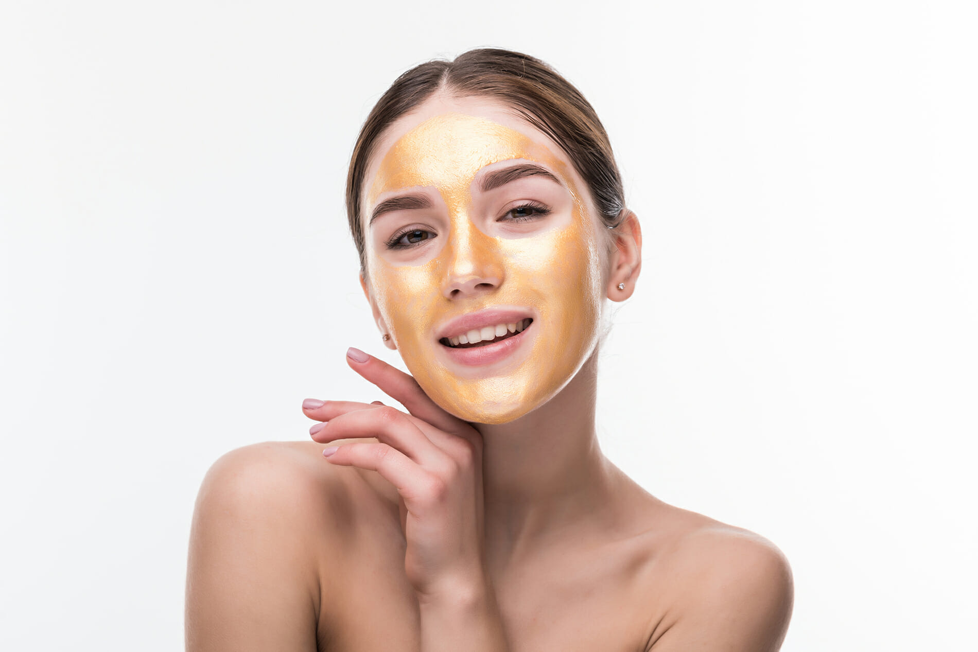 Woman with gold mask. Beautiful woman with Golden mask on face skin cosmetic touch Face. Beauty Skincare and Treatment